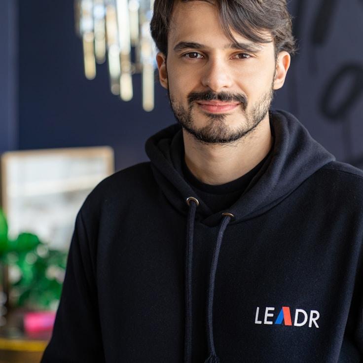 Avery Singh, Lead Design Curator at Lens Harbor Studio, reviewing corporate floral arrangements